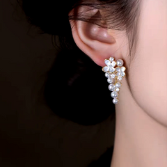 Model showcasing the dangle and style of the 14K Gold-Plated Elegant Oil Drop Flower Pearl Tassel Earrings