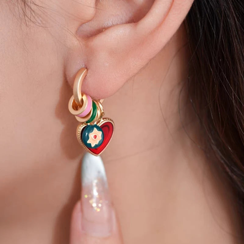 Model showcasing the dangle and style of the 14K Gold-Plated Elegant Oil Drop Heart Pendant Earrings
