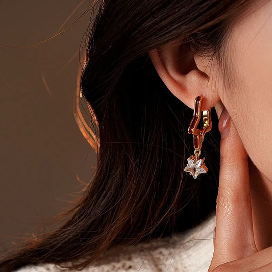 Model showcasing the dangle and style of the 14K Gold-Plated Elegant Oil Drop Zircon Star Earrings