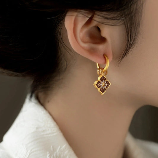 Model showcasing the dangle and style of the 14K Gold-Plated Elegant Painted Glazen Earrings