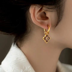 Model showcasing the dangle and style of the 14K Gold-Plated Elegant Painted Glazen Earrings
