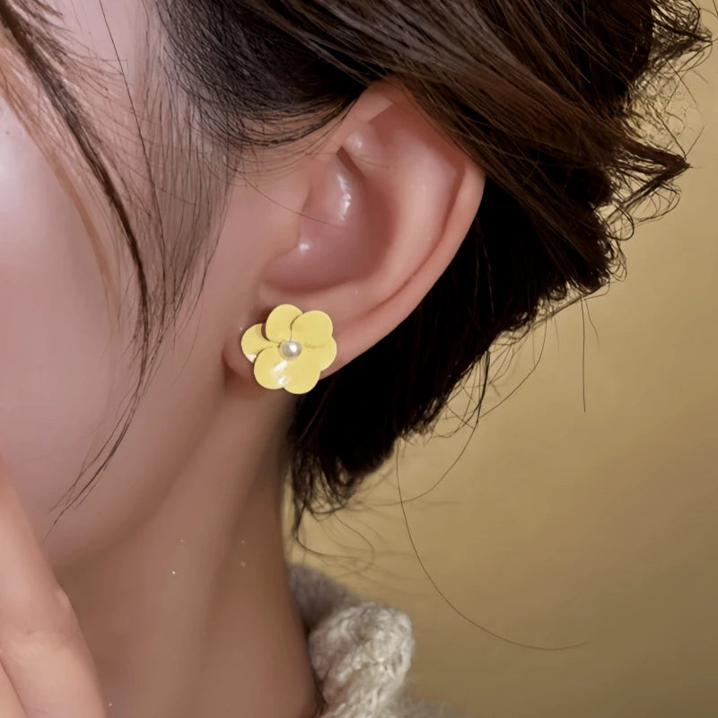 Close-up detail of the sparkling zircons and plating on the Yellow Flower Studs