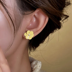 Close-up detail of the sparkling zircons and plating on the Yellow Flower Studs