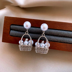 Angled view of the 14K Gold-Plated Elegant Pearl Basket Earrings