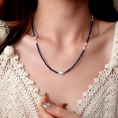 Close-up of the pendant and clasp on the Pearl Cross Necklace