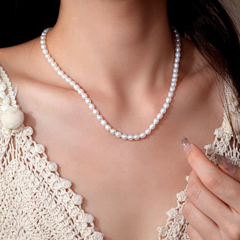 Detailed view of the 14K Gold-Plated Elegant Pearl Bead Cross Necklace chain and pendant