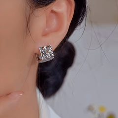 Model showcasing the dangle and style of the 14K Gold-Plated Elegant Pearl Double-Sided Textured Earrings