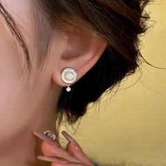 Model showcasing the dangle and style of the 14K Gold-Plated Elegant Pearl Earrings