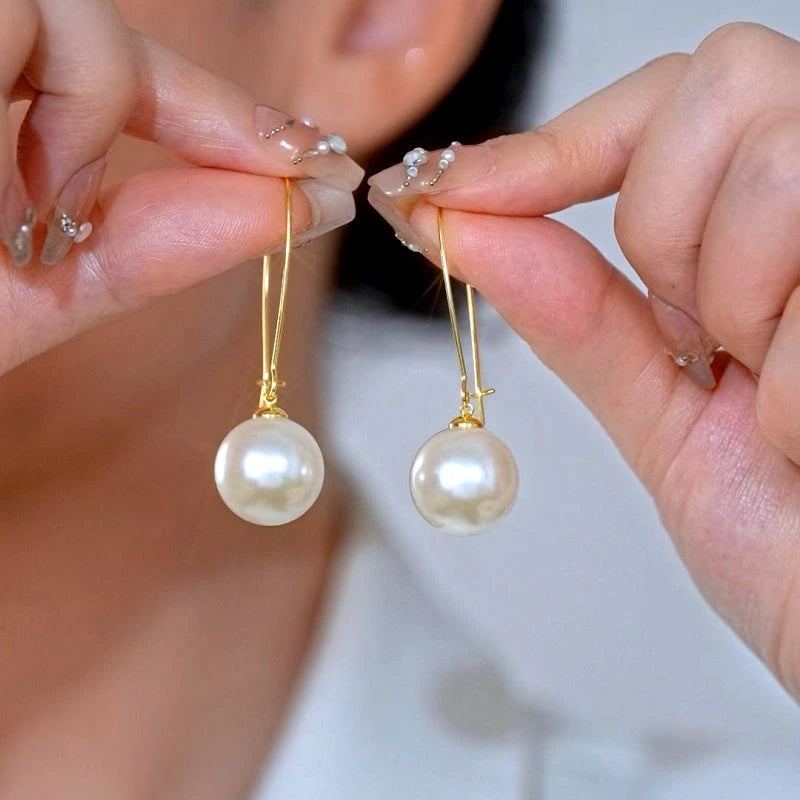 Angled view of the 14K Gold-Plated Elegant Pearl Earrings