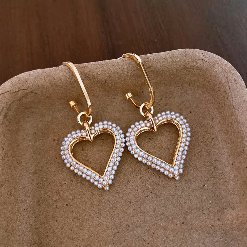 Close-up detail of the sparkling zircons and plating on the Pearl Heart Earrings