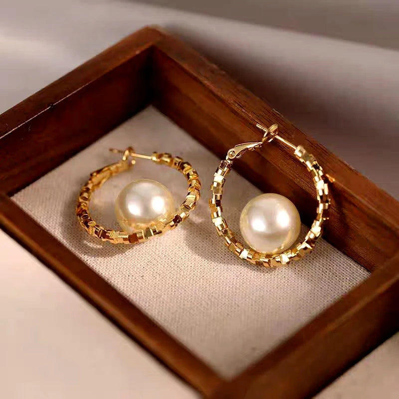 Close-up detail of the sparkling zircons and plating on the Pearl Hoop Earrings