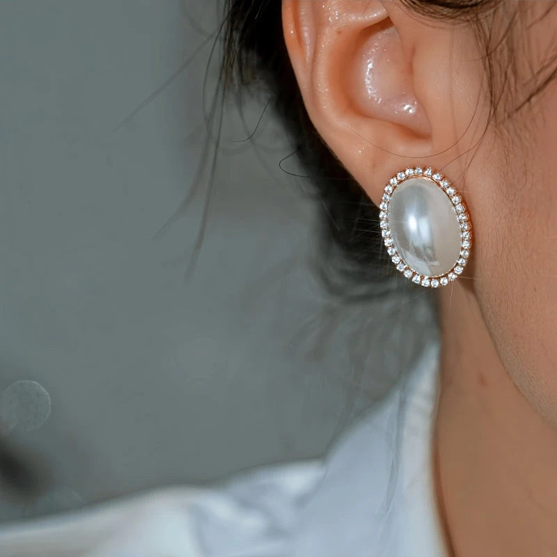 Model showcasing the dangle and style of the 14K Gold-Plated Elegant Pearl Stud Earrings