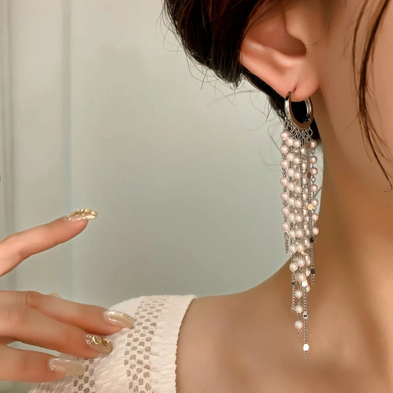 Model showcasing the dangle and style of the 14K Gold-Plated Elegant Pearl Tassel Earrings