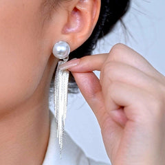 Model showcasing the dangle and style of the 14K Gold-Plated Elegant Pearl Tassel Earrings