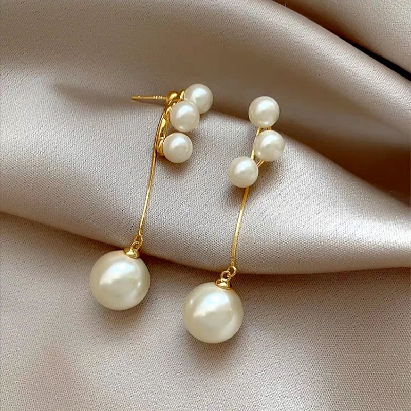 Angled view of the 14K Gold-Plated Elegant Pearl Tassel Earrings
