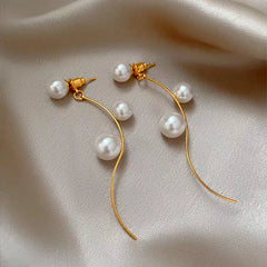 Angled view of the 14K Gold-Plated Elegant Pearl Tassel Earrings
