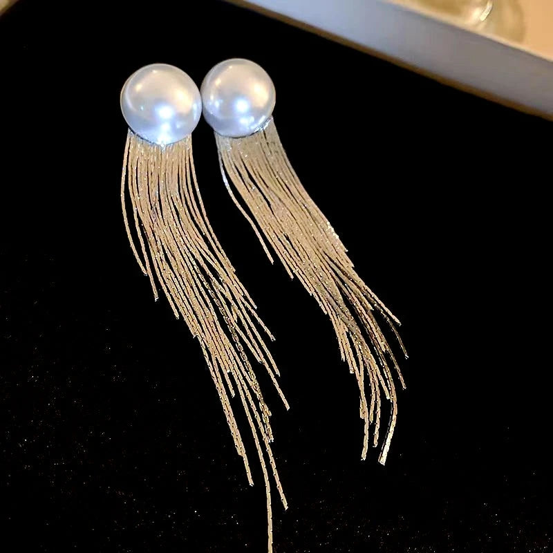 Angled view of the 14K Gold-Plated Elegant Pearl Tassel Earrings