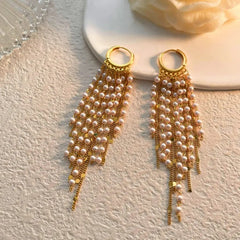 Angled view of the 14K Gold-Plated Elegant Pearl Tassel Earrings