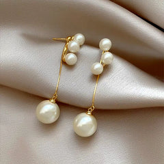 Angled view of the 14K Gold-Plated Elegant Pearl Tassel Earrings