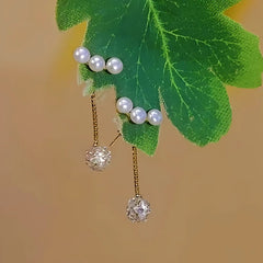 Close-up detail of the sparkling zircons and plating on the Pearl Zircon Tassel Earrings