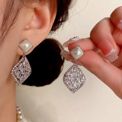 Model showcasing the dangle and style of the 14K Gold-Plated Elegant Pearl Zircon Diamond Water Drop Earrings