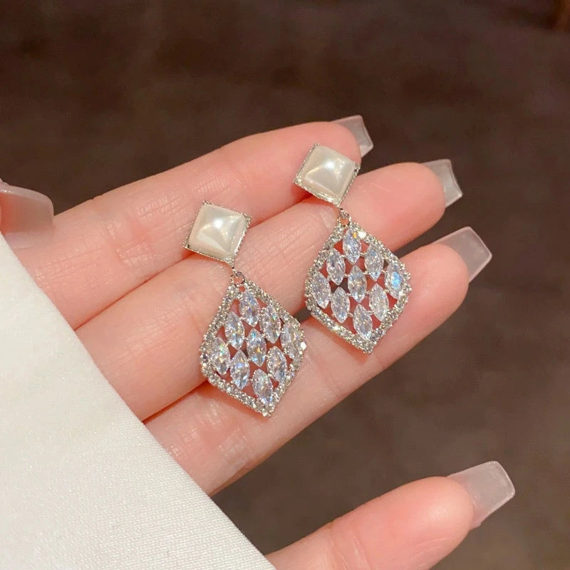 Angled view of the 14K Gold-Plated Elegant Pearl Zircon Diamond Water Drop Earrings