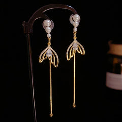 Close-up detail of the sparkling zircons and plating on the Fishtail Tassel Earrings