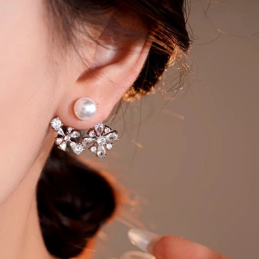 Model showcasing the dangle and style of the 14K Gold-Plated Elegant Pearl Zircon Flower Jacket Earrings