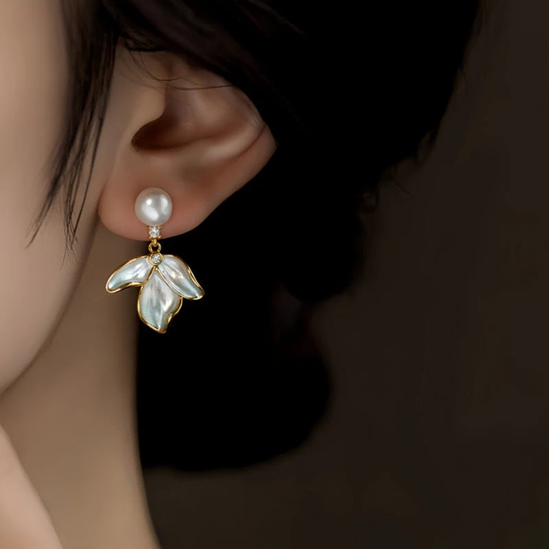 Model showcasing the dangle and style of the 14K Gold-Plated Elegant Petal Pearl Earrings