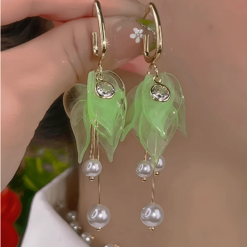 Model showcasing the dangle and style of the 14K Gold-Plated Elegant Petal Pearl Tassel Earrings