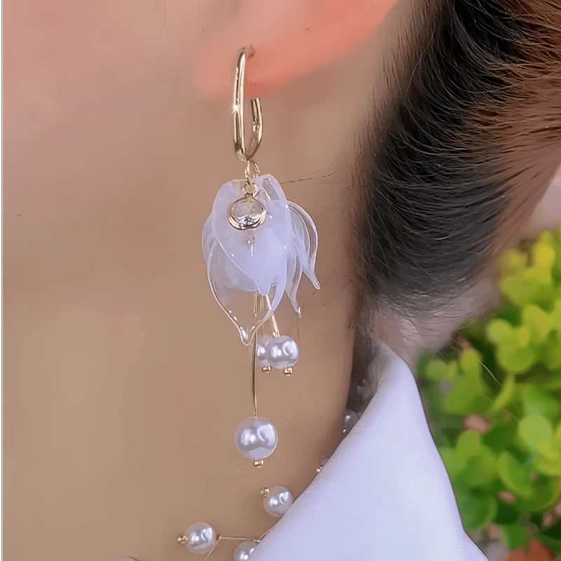 Close-up detail of the sparkling zircons and plating on the Petal Pearl Tassel Earrings