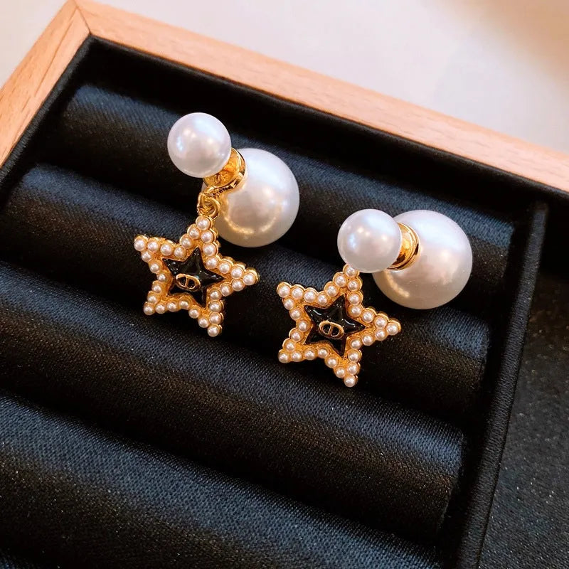 Angled view of the 14K Gold-Plated Elegant Pig Nose Star Pearl Earrings