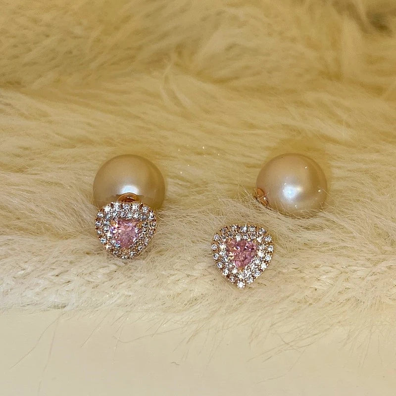 Model showcasing the dangle and style of the 14K Gold-Plated Elegant Pink Diamond Heart Pearl Earrings