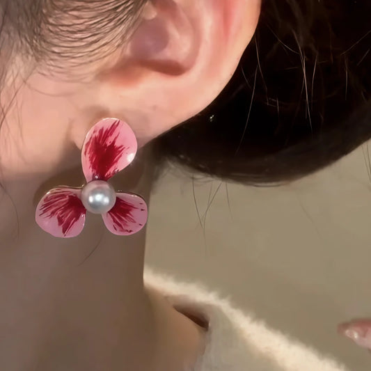 Model showcasing the dangle and style of the 14K Gold-Plated Elegant Pink Flower Pearl Stud Earrings