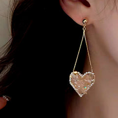 Close-up detail of the sparkling zircons and plating on the Pink Heart Tassel Earrings