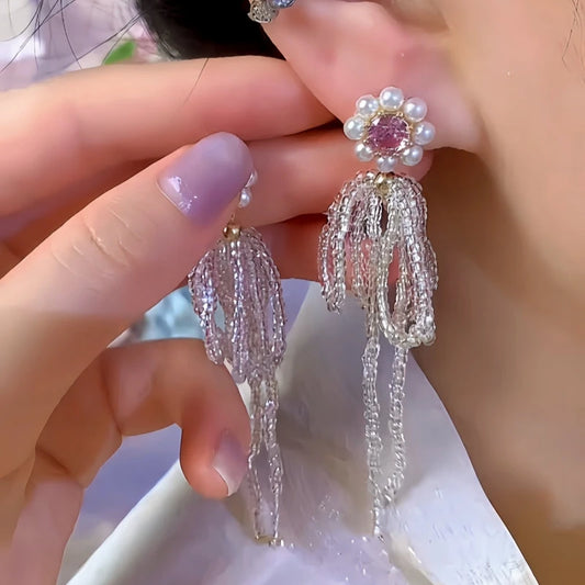 Model showcasing the dangle and style of the 14K Gold-Plated Elegant Pink Zircon Diamond Bead Flower Tassel Earrings