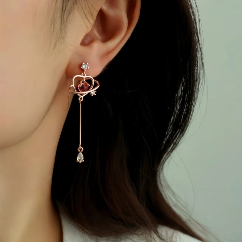 Model showcasing the dangle and style of the 14K Gold-Plated Elegant Pink Zircon Diamond Heart Tassel Earrings