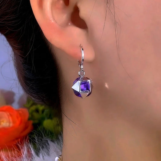 Model showcasing the dangle and style of the 14K Gold-Plated Elegant Purple Cube Earrings