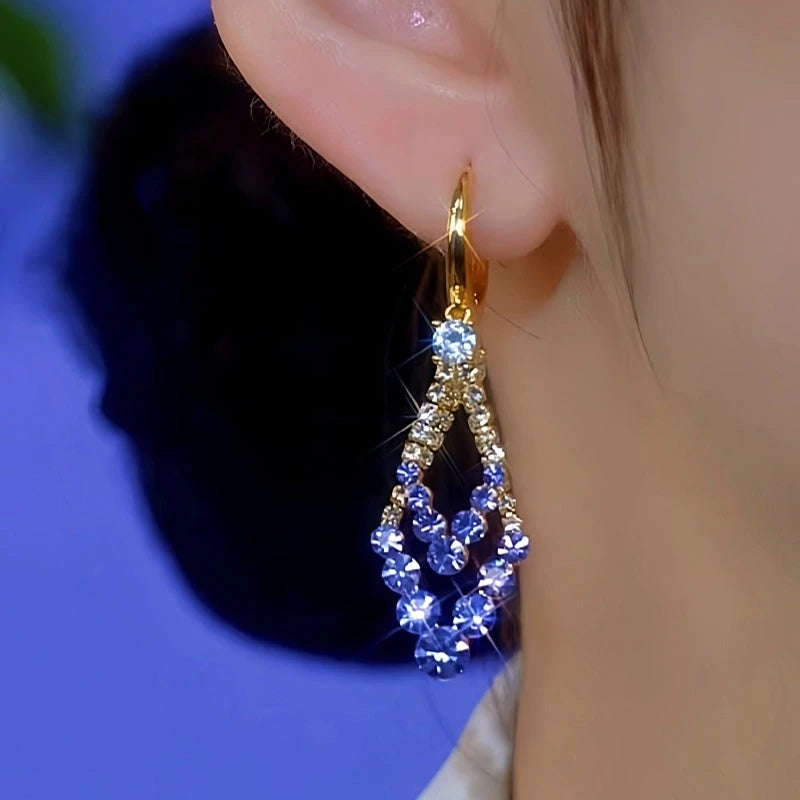 Model showcasing the dangle and style of the 14K Gold-Plated Elegant Purple Diamond Earrings