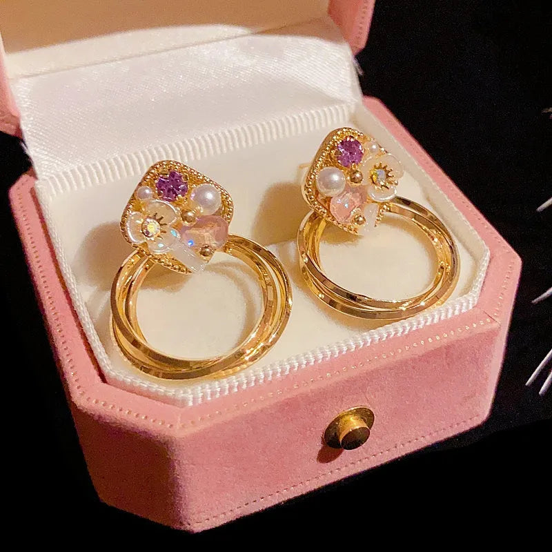 Close-up detail of the sparkling zircons and plating on the Flower Pearl Hoop Earrings