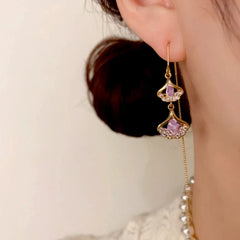 Model showcasing the dangle and style of the 14K Gold-Plated Elegant Purple Ginkgo Leaf Tassel Threader Earrings