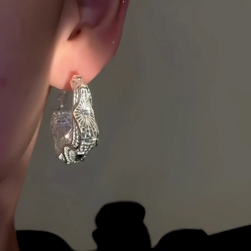 Model showcasing the dangle and style of the 14K Gold-Plated Elegant Purple Hollow Hoop Earrings