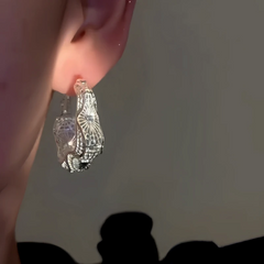 Model showcasing the dangle and style of the 14K Gold-Plated Elegant Purple Hollow Hoop Earrings