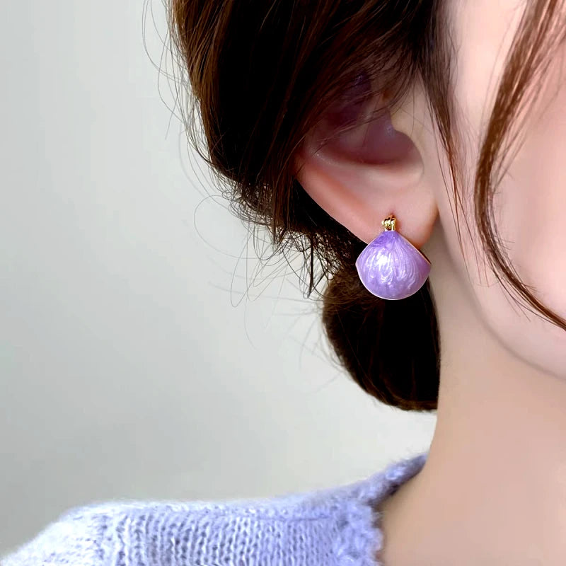 Model showcasing the dangle and style of the 14K Gold-Plated Elegant Purple Oil Drop Basket Earrings