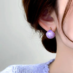 Model showcasing the dangle and style of the 14K Gold-Plated Elegant Purple Oil Drop Basket Earrings
