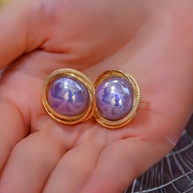 Angled view of the 14K Gold-Plated Elegant Purple Pearl Stud Earrings