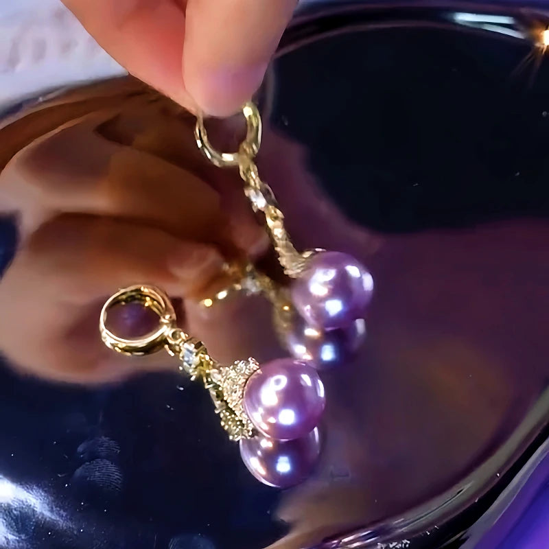 Angled view of the 14K Gold-Plated Elegant Purple Pearl Zircon Crown Earrings