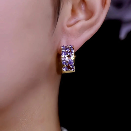 Model showcasing the dangle and style of the 14K Gold-Plated Elegant Purple Zircon DIamond Hoop Earrings