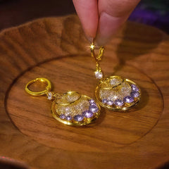 Close-up detail of the sparkling zircons and plating on the Purple Zircon Mesh Hoops