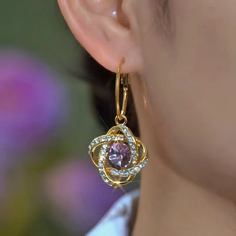 Model showcasing the dangle and style of the 14K Gold-Plated Elegant Purple Zircon Diamond Three-Dimensional Earrings